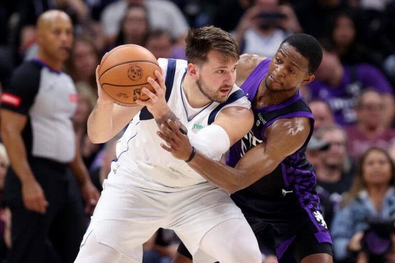 SACRAMENTO, CALIFORNIA - MARCH 26: De'Aaron Fox #5 of the Sacramento Kings guards Luka Doncic #77 of the Dallas Mavericks in the first half at Golden 1 Center on March 26, 2024 in Sacramento, California. NOTE TO USER: User expressly acknowledges and agrees that, by downloading and or using this photo, User agrees to the terms and conditions of the Getty Images License Agreement. (Photo by Ezra Shaw/Getty Images)