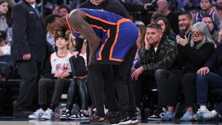 January 27, 2024; New York, New York, USA; New York Knicks forward Julius Randle (30) is helped by medical staff after an injury during the second half against the Miami Heat at Madison Square Garden.