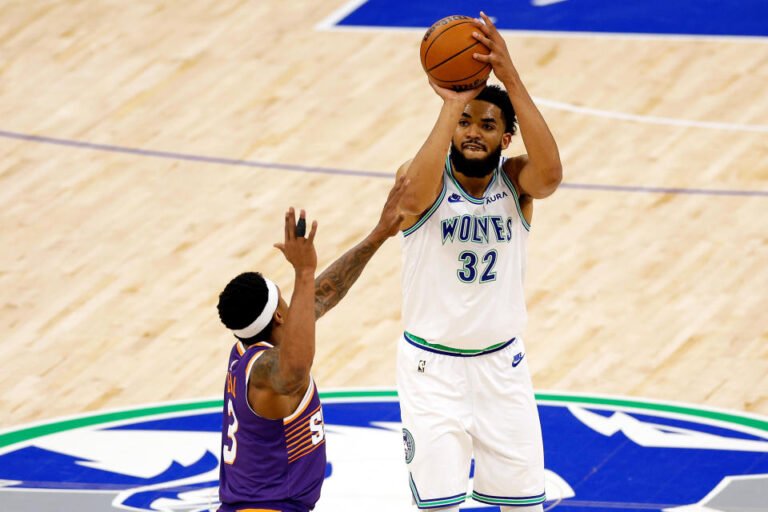 MINNEAPOLIS, MINNESOTA - APRIL 23: Karl-Anthony Towns #32 of the Minnesota Timberwolves shoots against Bradley Beal #3 of the Phoenix Suns in the first quarter of Game 2 of the Western Conference First Round Playoffs at Target Center on April 23 April 2024 in Minneapolis, Minnesota. NOTE TO USER: User expressly acknowledges and agrees that, by downloading and or using this photo, User agrees to the terms and conditions of the Getty Images License Agreement. (Photo by David Berding/Getty Images)