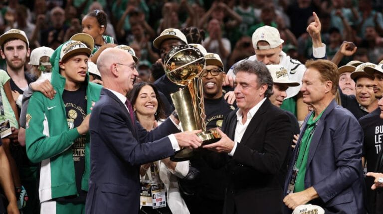 BOSTON, MASSACHUSETTS - JUNE 17: NBA Commissioner Adam Silver presents majority owner Wyc Grousbeck of the Boston Celtics with the Larry O'Brien Championship Trophy following Boston's 106-88 victory over the Dallas Mavericks in Game Five of the NBA Finals 2024 at TD Garden in June. 17, 2024 in Boston, Massachusetts. NOTE TO USER: User expressly acknowledges and agrees that, by downloading and or using this photo, User agrees to the terms and conditions of the Getty Images License Agreement. (Photo by Elsa/Getty Images)