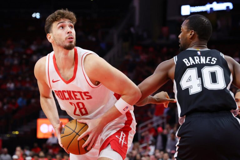 HOUSTON, TEXAS - OCTOBER 17: Alperen Sengun #28 of the Houston Rockets works to the basket against Harrison Barnes #40 of the San Antonio Spurs during the first half of a preseason game at Toyota Center on October 17, 2024 in Houston, Texas. NOTE TO USER: User expressly acknowledges and agrees that, by downloading and or using this photo, User agrees to the terms and conditions of the Getty Images License Agreement. (Photo by Alex Slitz/Getty Images)