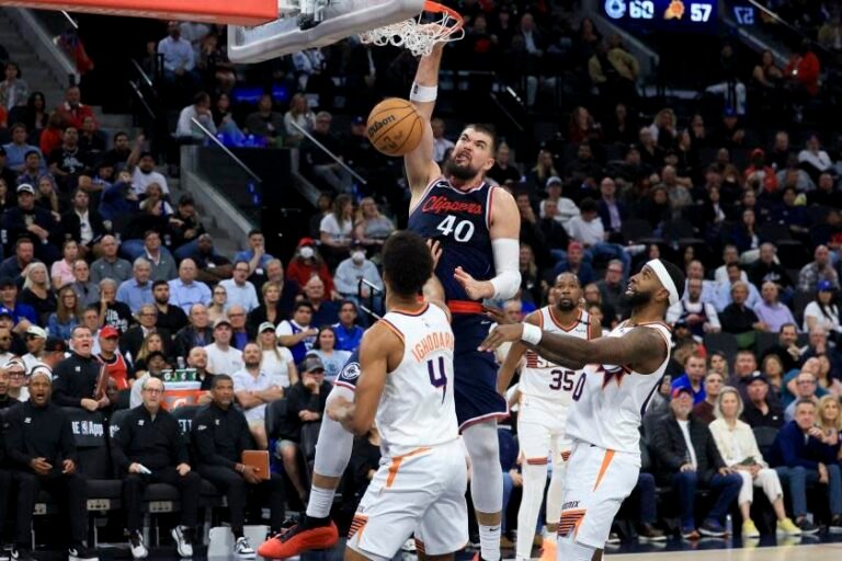 Clippers center Ivica Zubac (40) drives the ball against Phoenix Suns center Oso Ighodaro (4) during the second half of an NBA basketball game, Wednesday, Oct. 23, 2024, in Inglewood, Calif. (AP Photo/Ryan sun)