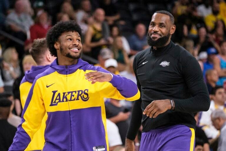 Los Angeles Lakers guard Bronny James, left, and forward LeBron James warm up before a preseason game