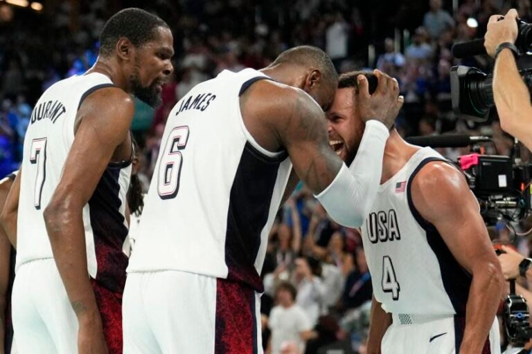 Stephen Curry, right, celebrates with LeBron James, center, and Kevin Durant after the U.S. basketball team defeats Serbia.