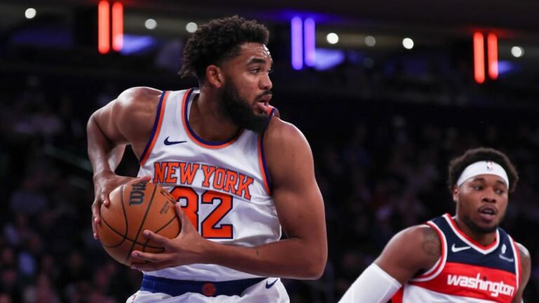 New York, New York, USA; New York Knicks center Karl-Anthony Towns (32) secures a rebound in front of Washington Wizards guard Bilal Coulibaly (0) during the first half at Madison Square Garden.