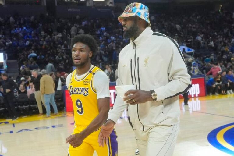 Los Angeles Lakers guard Bronny James (9) leaves the floor with forward LeBron James.