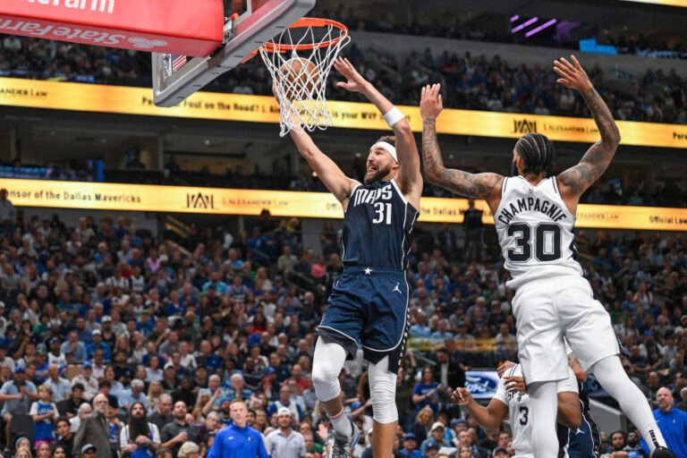 Dallas Mavericks guard Klay Thompson (31) goes for a layup while being guarded by San Antonio Spurs forward Julian Champagnie (30) during the second half of an NBA basketball game, Thursday, Oct. 24, 2024, in Dallas , Texas. . (AP Photo/Albert Pena)