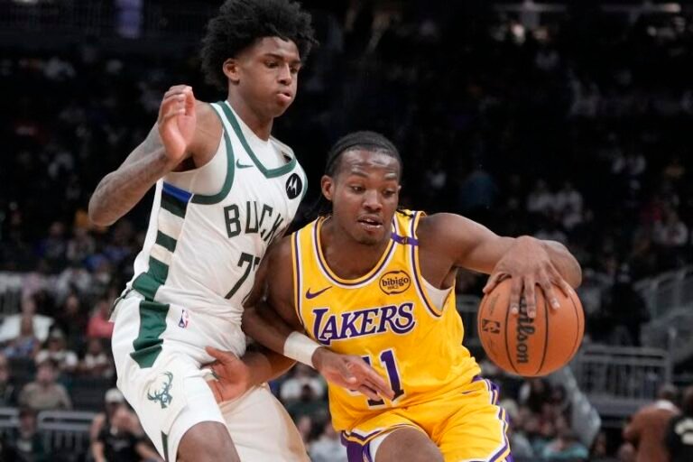 The Lakers' Quincy Olivari tries to pass the Bucks' AJ Johnson during a preseason game Thursday in Milwaukee.