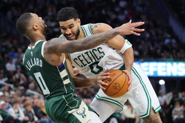 MILWAUKEE, WISCONSIN - NOVEMBER 10: Jayson Tatum #0 of the Boston Celtics is defended by Damian Lillard #0 of the Milwaukee Bucks during the second half of a game at Fiserv Forum on November 10, 2024 in Milwaukee, Wisconsin. NOTE TO USER: User expressly acknowledges and agrees that, by downloading and or using this photo, User agrees to the terms and conditions of the Getty Images License Agreement. (Photo by Stacy Revere/Getty Images)