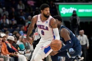 Philadelphia 76ers forward Paul George (8) handles the ball in front of Memphis Grizzlies forward Jaren Jackson Jr. (13) in the first half of an NBA basketball game Wednesday, Nov. 20, 2024, in Memphis, Tenn. (AP Photo/Brandon) dill)